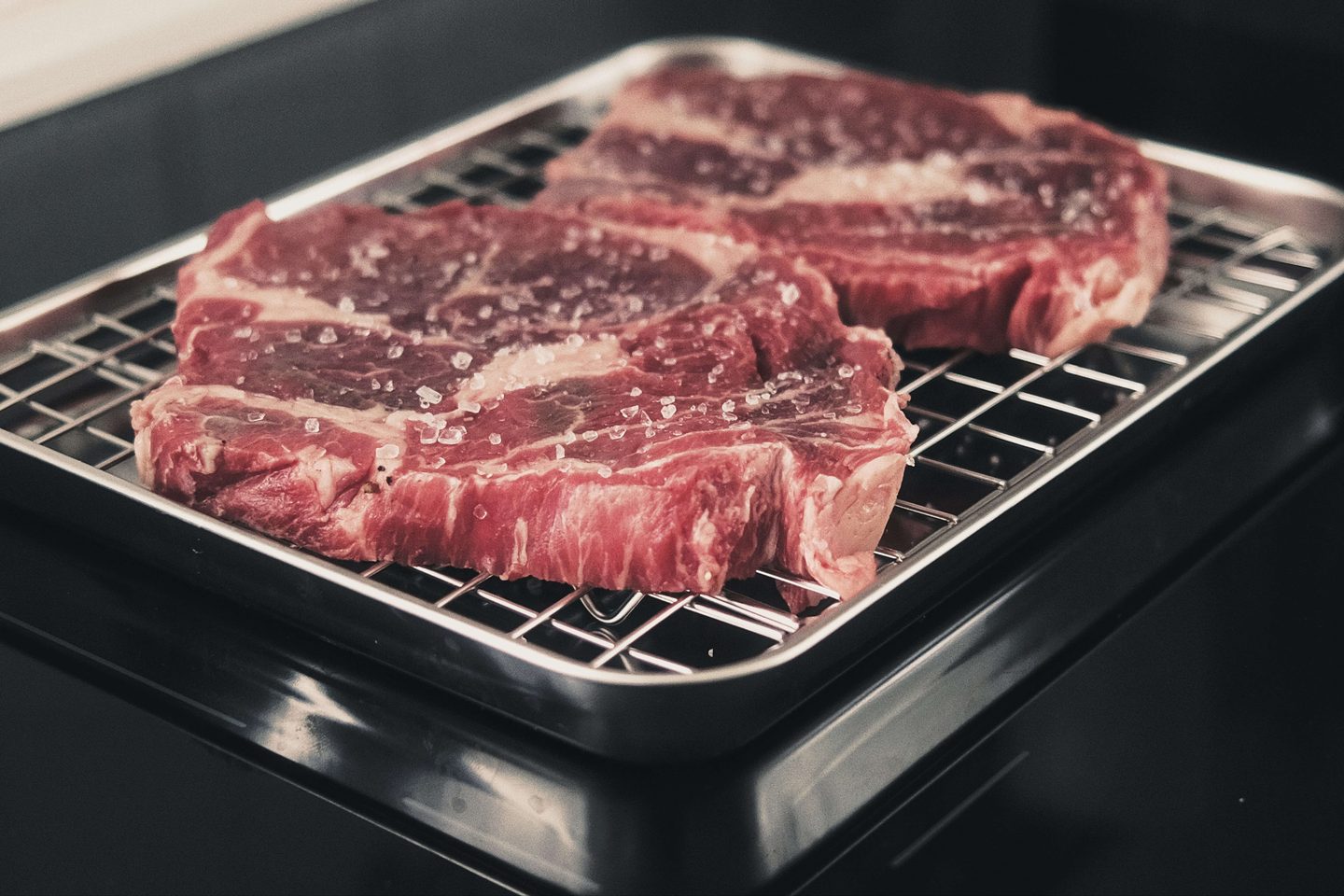 Raw ribeye steaks prepared for cooking, representing high-protein carnivore foods.