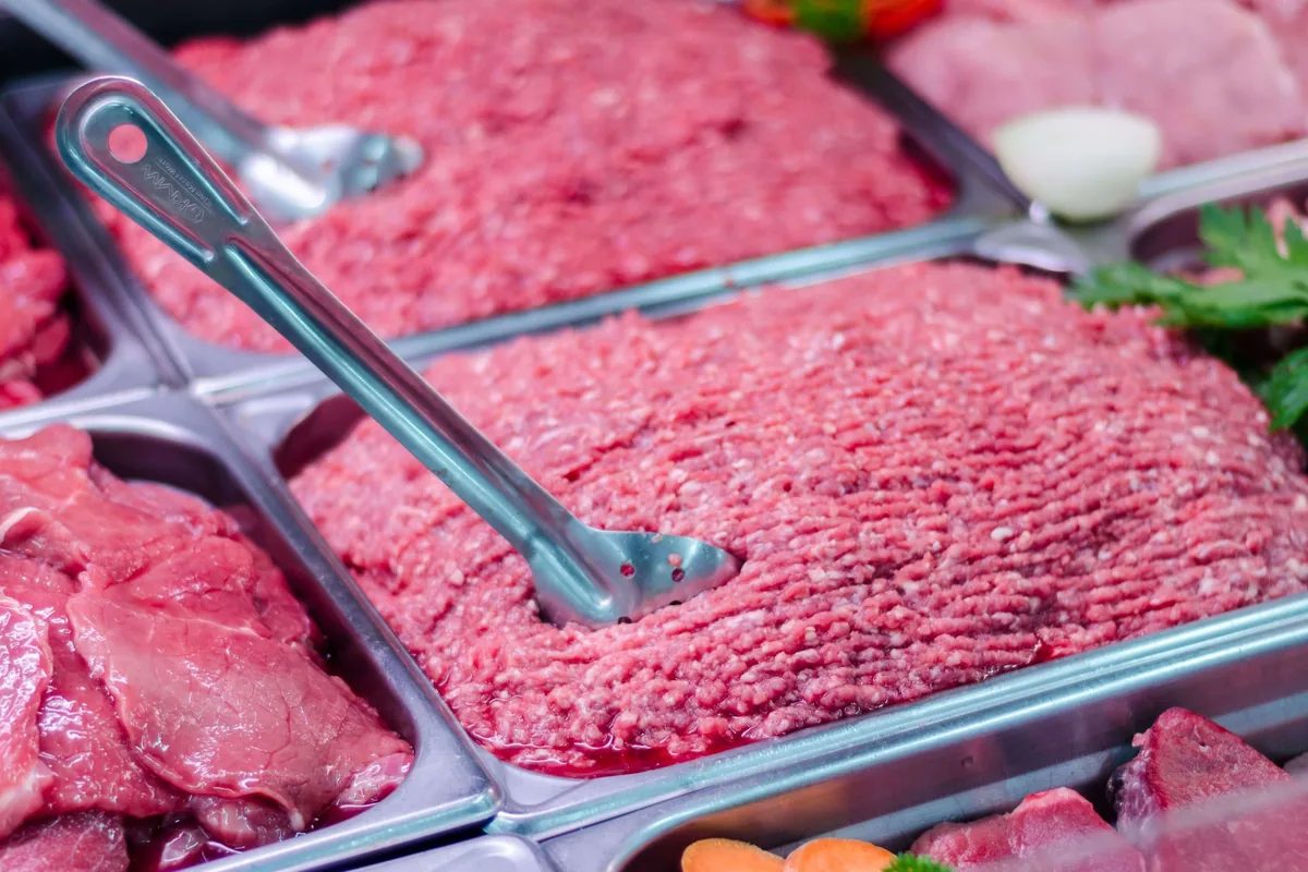 Ground beef displayed at a butcher counter